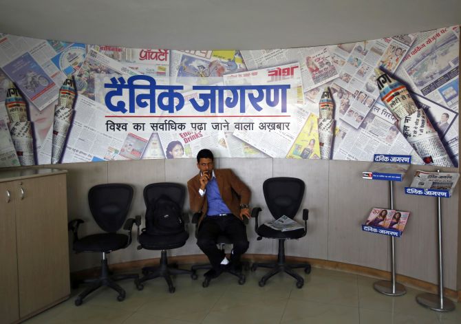 A visitor waits at the reception area of the Dainik Jagran newspaper's office in Noida.