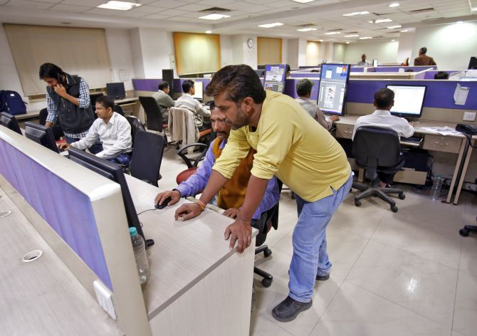 Employees work inside the office of Dainik Jagran newspaper in Noida.