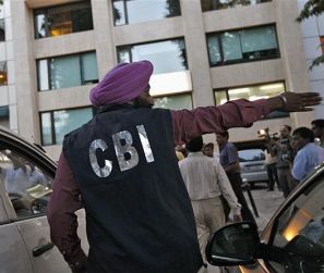 A CBI official outside the New Delhi office of the Abhijeet Group, which owns Jas Infrastructure, after conducting a raid on September 4, 2012.