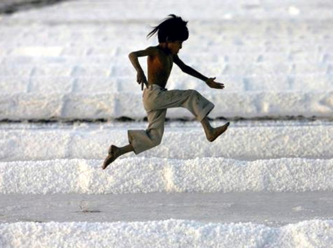 A worker's son plays in a salt pan near Bhavnagar in Gujarat.