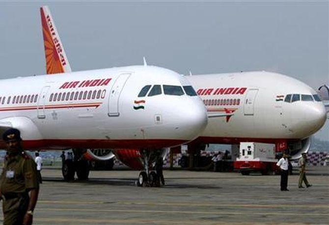 Air India's newly acquired Airbus A321 (L) and Boeing 777-200 LR aircrafts are on display at the tarmac of Mumbai airport.