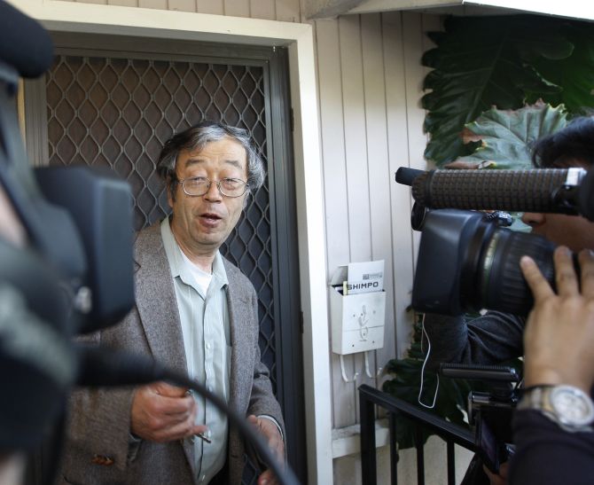 A man widely believed to be Bitcoin currency founder Satoshi Nakamoto is surrounded by reporters as he leaves his home in Temple City.
