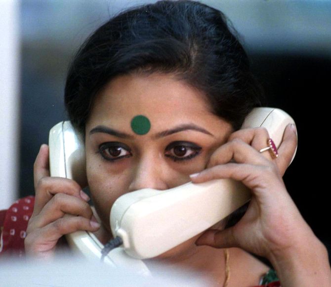 A dealer in Bombay talks into two phones at the same.