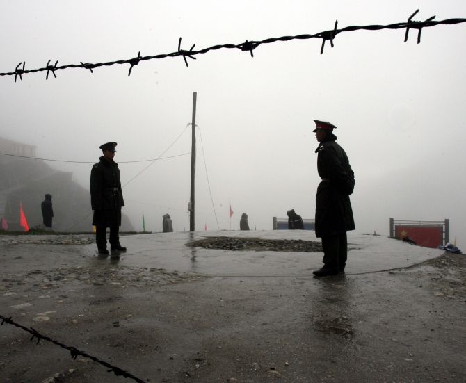 Chinese guards stand near the India-China border at Nathula, Sikkim