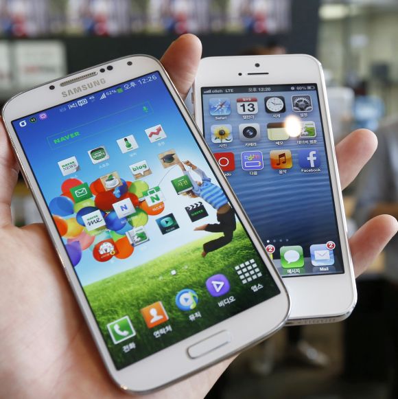 Samsung Electronics' Galaxy S4 (L) and Apple's iPhone 5 are seen in this picture illustration.