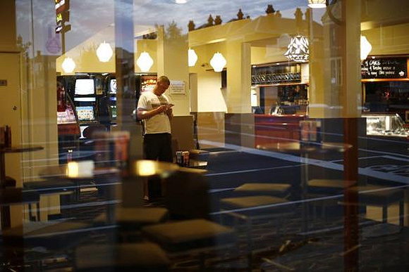 A customer is seen through the window of a pub in Geelong.