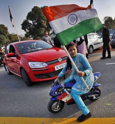 A woman holds an Indian flag