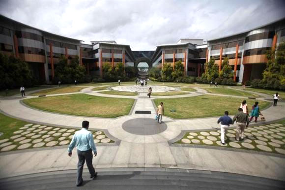 Employees walk in a forecourt at the Infosys campus in the Electronic City area of Bangalore. The initiatives taken by N R Narayana Murthy has not yet reflected in the company's performance.