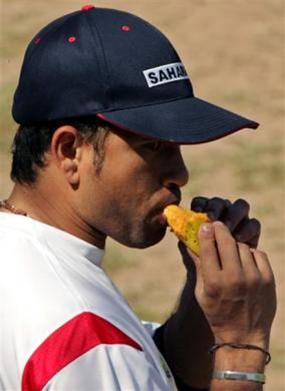 Sachin Tendulkar eats a mango during a break in a practice in Mohali, March 6, 2005.