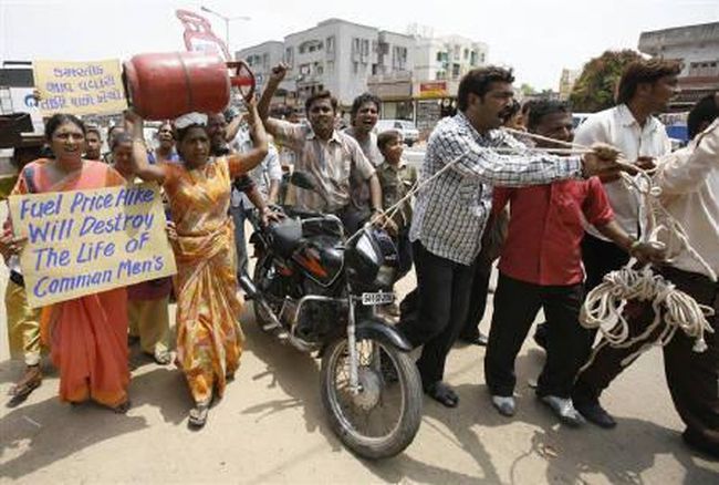 Citizens protest after the govt capped subsidy on LPG cylinders.