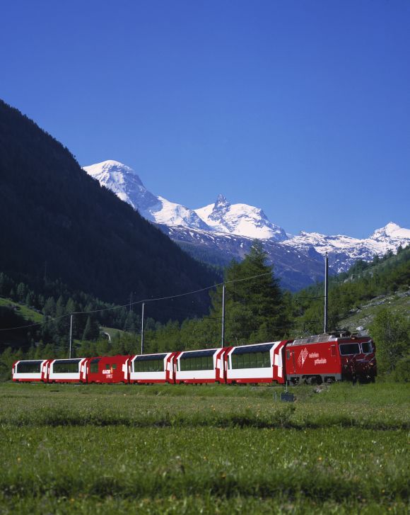 Glacier Express travelling in front of 'Breithorn' and 'Little Matterhorn' mountains.