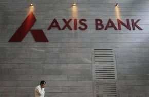An employee speaks on his mobile phone as he walks inside Axis Bank's corporate headquarters in Mumba
