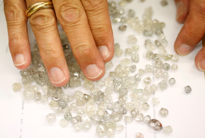 Diamond buyer Elliot Tannenbaum, from the Leo Schachter Diamond Group, looks at uncut diamonds from his company's allocation at a sightholders week at De Beers offices in central London.