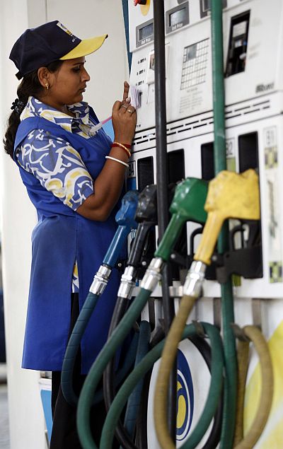 A woman employee works at a petrol pump in the eastern Indian city of Kolkata.