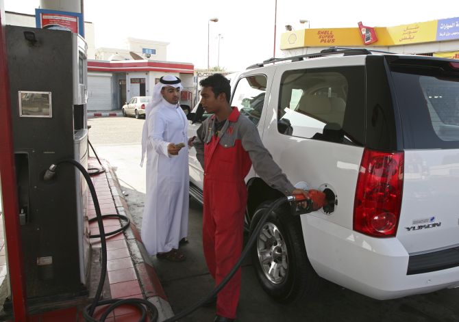 A station attendant fills up a car at petrol station in Jeddah.
