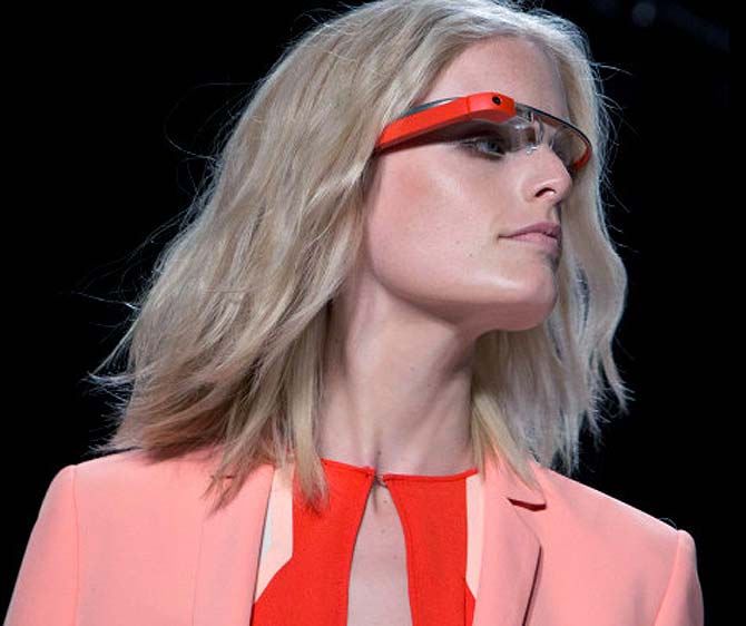 A model wear rocks an orange pair of Google Glasses at the Diane von Furstenberg Spring/Summer 2013 runway show during New York Fashion Week.