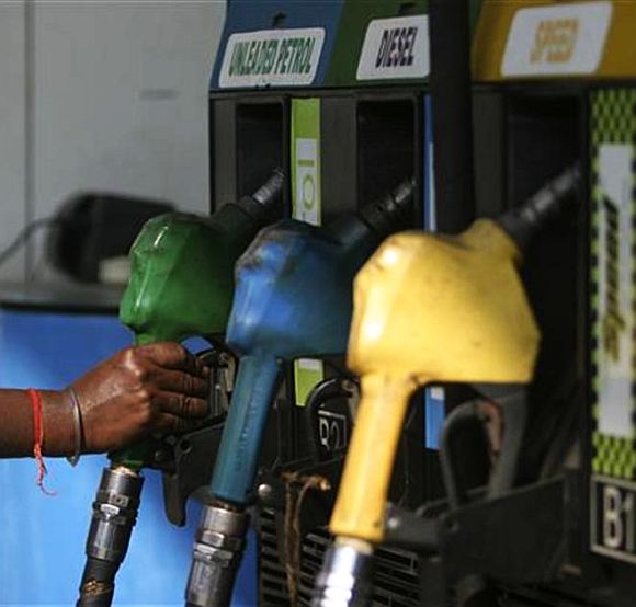 An Attendant about to fill up petrol at a pump in Mumbai.