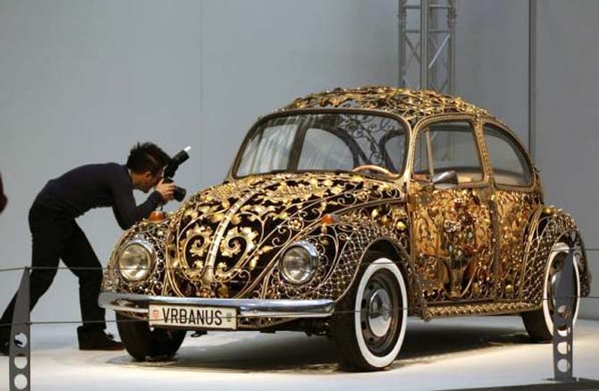 A visitor takes a picture of a modified Volkswagen Beetle during a press presentation prior to the Essen Motor Show in Essen, Germany.