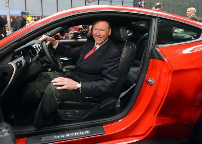 Alan Mulally, President and CEO, Ford Motor Co. in the driver's seat of the new 2013 Ford Fusion during the Charity Preview at the 2012 North American International Auto Show.