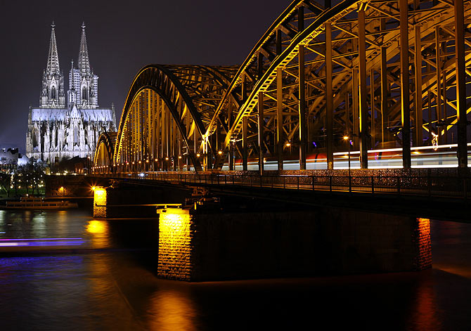 The UNESCO World Heritage Cologne Cathedral and the Hohenzollern railway bridge along the river Rhine is seen before Earth Hour.