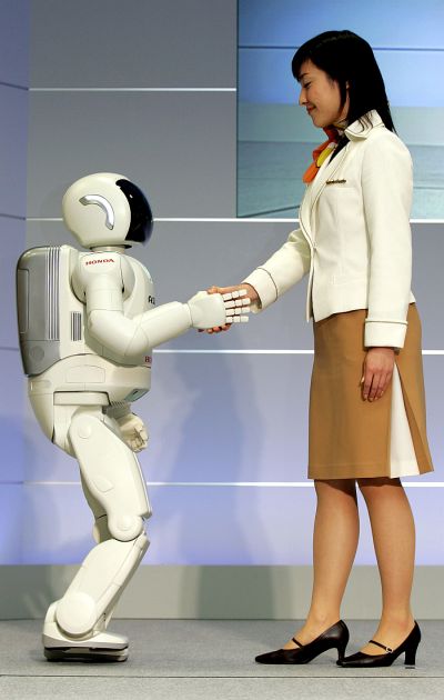 Honda Motor's humanoid robot,next-generation ASIMO steps in the direction being pushed by a model at Honda's office in Wako.