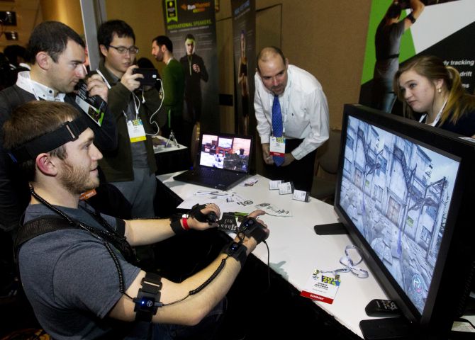 YEI Technology's Chris George plays a computer game with PrioVR, a virtual reality gaming accessory, during CES Unveiled, a media preview event to the annual Consumer Electronics Show (CES), in Las Vegas, Nevada.