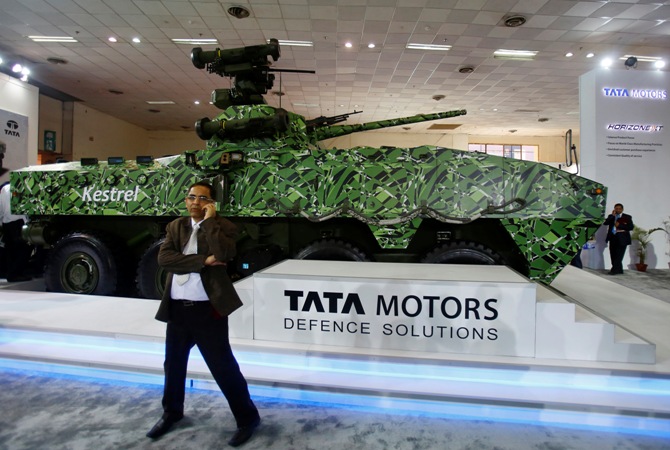 A visitor speaks on his mobile phone in front of Tata Motors' Kestrel, an armoured personnel carrier, at a defence exhibition in New Delhi.