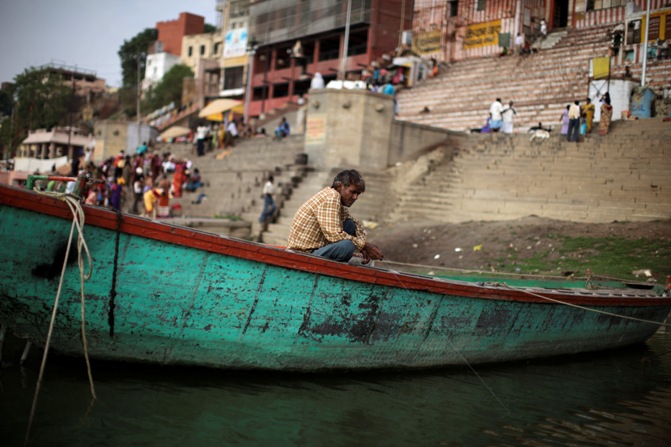 A man fishes at the banks of river Ganges in Varanasi.