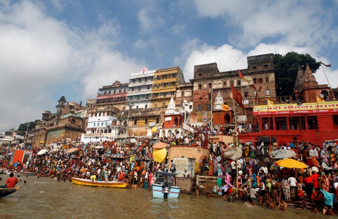 Hindu devotees gather along the banks of River Ganges to watch a total solar eclipse in Varanasi.