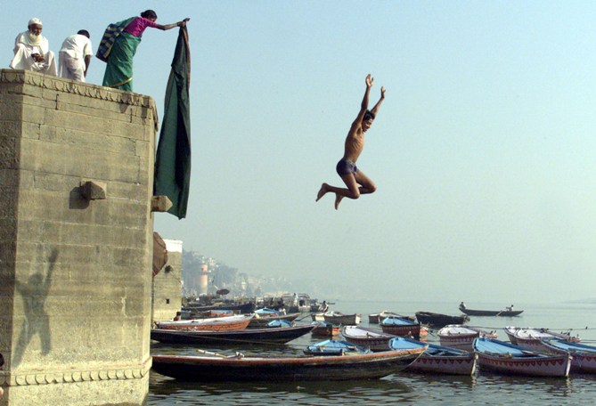 An Indian youth jumps into the water on the banks of Ganges in Varanasi.
