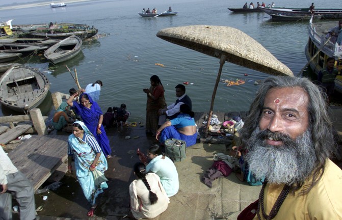 A Hindu holy man stands on the banks of the Ganges in Varanasi.