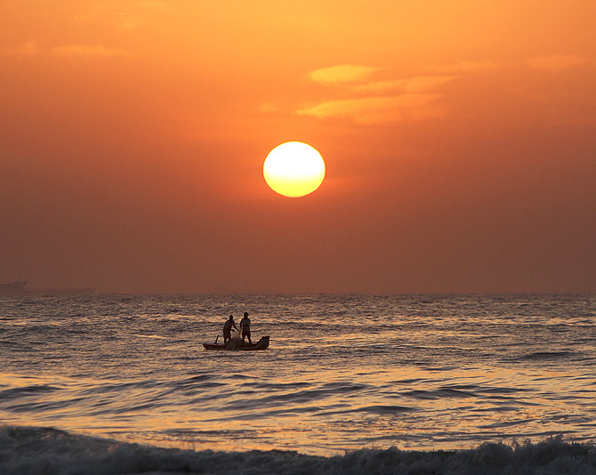 Fishermen pull their fishing net from the waters of Bay of Bengal during sunrise in the southern Indian city of Chennai.