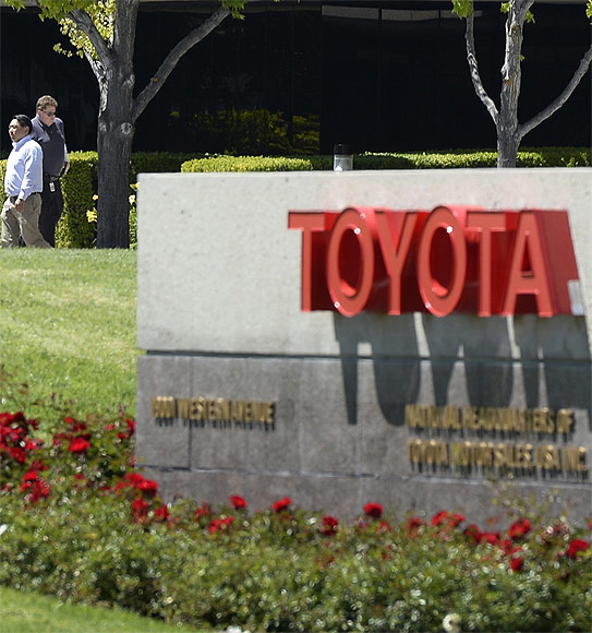 People walk at the national headquarters of Toyota Motor Sales USA.