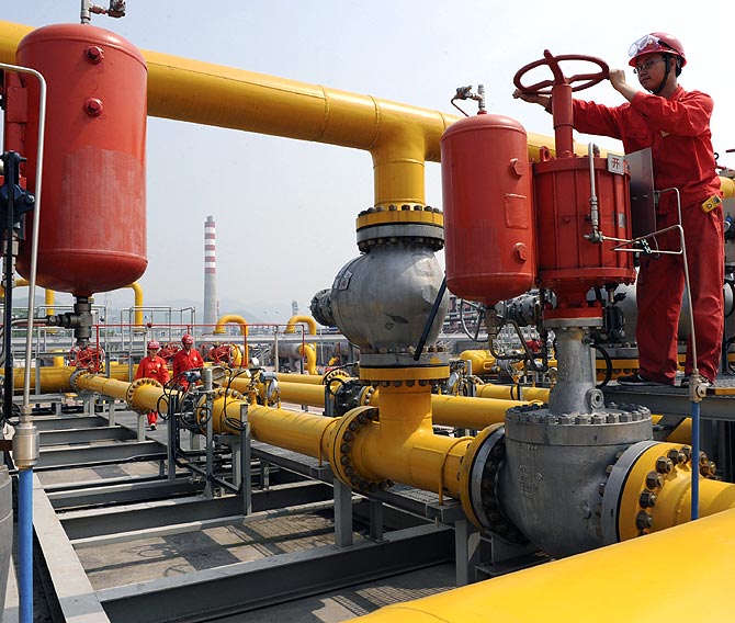 An employee checks on Sinopec natural gas transmission facilities in Xuanhan county, Sichuan province.