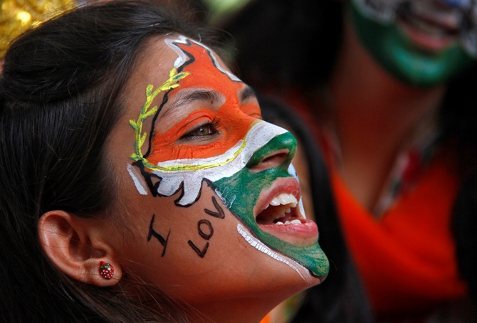 A girl, with her face painted in the colours of India's national flag, chants slogans as she takes part in a cultural program to celebrate India's Independence Day in Chandigarh.