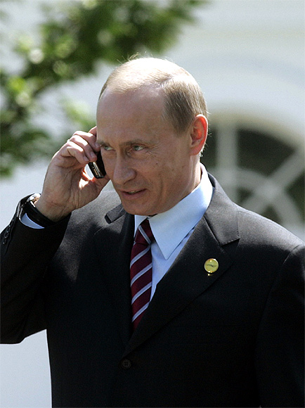 Russian President Vladimir Putin talks on the phone.