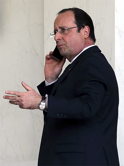 French President Francois Hollande speaks on his phone at the Elysee Palace in Paris.