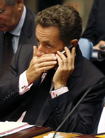 Former French President Nicolas Sarkozy talks on a mobile phone at a Security Council Summit meeting during the United Nations General Assembly at the U.N. headquarters in New York.