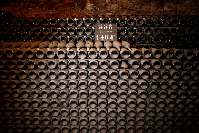Billecart-Salmon Champagne bottles are stacked in a cellar.