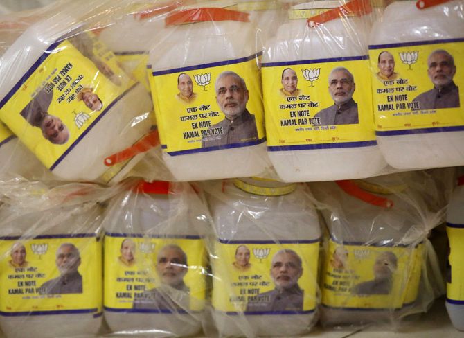 Plastic jars with images of Hindu nationalist Narendra Modi (R), the prime ministerial candidate for India's main opposition BJP, and party's president Rajnath Singh, are seen stacked atop of each other at the party's regional office in New Delhi.