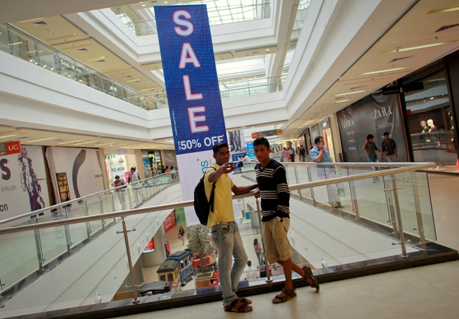 A shopper takes a photograph with his mobile phone inside a shopping mall in Mumbai.