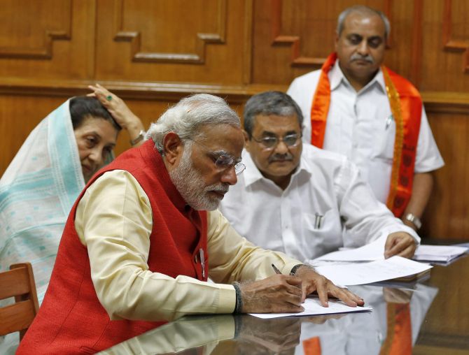 Hindu nationalist Narendra Modi, prime ministerial candidate for India's main opposition Bharatiya Janata Party (BJP), signs his nomination papers for the general elections in Vadodara.