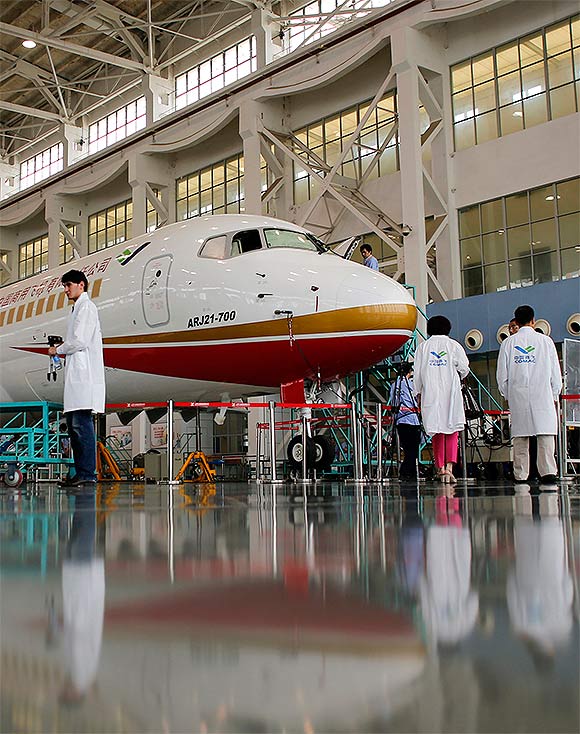 Members of the media visit a ARJ21-700 aircraft model at the Commercial Aircraft Corp of China Ltd (Comac) factory in Shanghai.