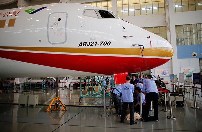 Technicians inspect a ARJ21-700 aircraft model at the Commercial Aircraft Corp of China Ltd (Comac) factory in Shanghai.