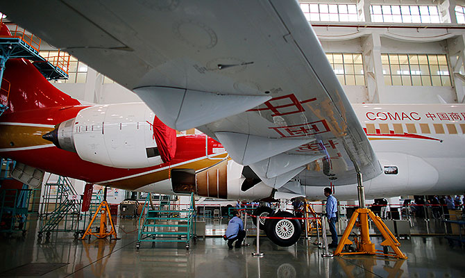 Technicians inspect a ARJ21-700 aircraft model at the Commercial Aircraft Corp of China Ltd (Comac) factory in Shangha3.