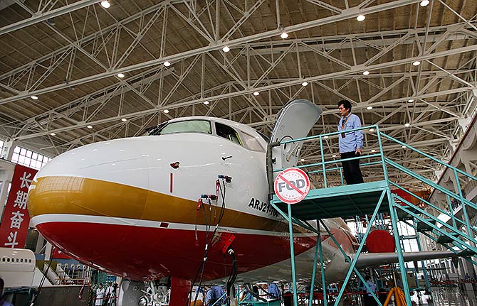 A technician inspects a ARJ21-700 aircraft model at the Commercial Aircraft Corp of China Ltd (Comac) factory in Shanghai.