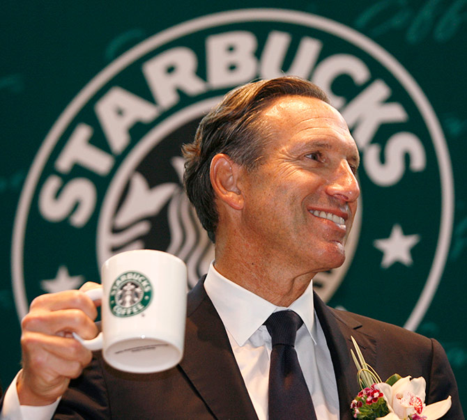 Starbucks Chief Executive Howard Schultz tastes a cup of coffee as he attends a ceremony marking the 10th anniversary of the opening of the first Hong Kong Starbucks.