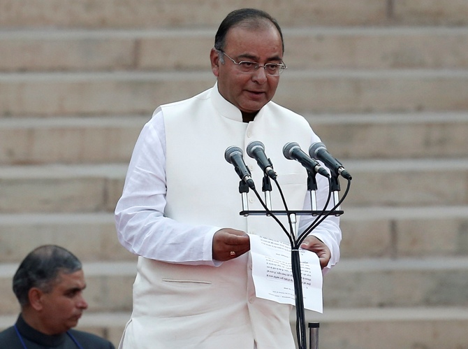 Arun Jaitley is administered oath of office by President Pranab Mukherjee (unseen) as a Cabinet minister at the Rashtrapati Bhavan in New Delhi May 26, 2014.