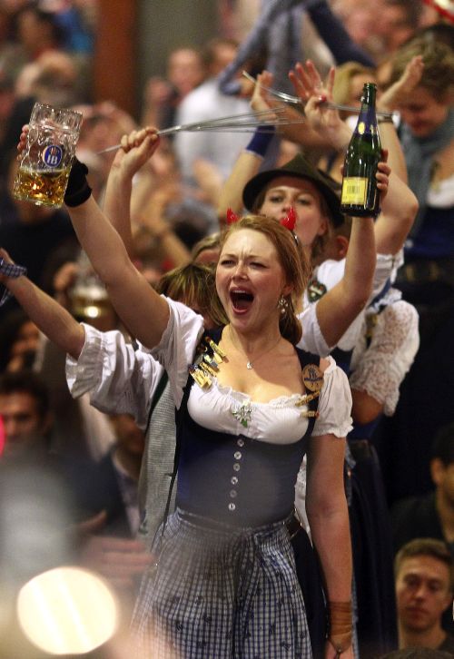 Oktoberfest waitresses dance on the tables while they celebrate the end of the world biggest beer festival.
