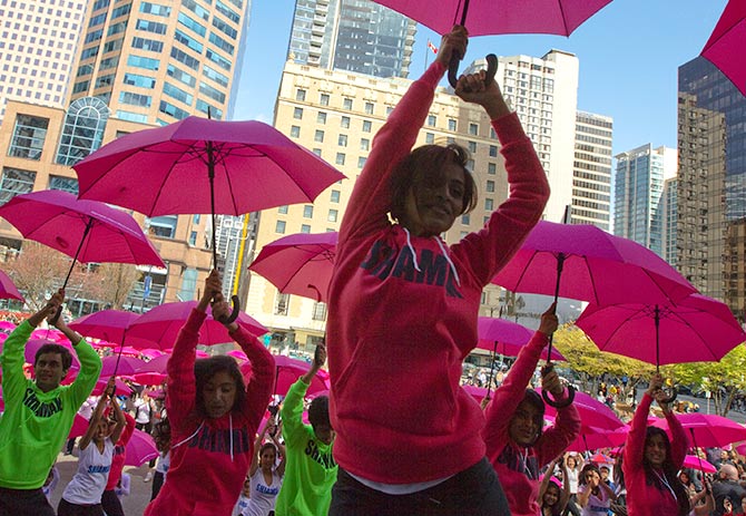 Dancers perform with pink umbrellas, while dancing to the Bollywood song Zoobi Doobi, during the annual Cherry Blossom Festival celebrations in Vancouver.